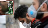 İranlı vatandaş, koronavirüsten korunmak için demir korkulukları yaladı