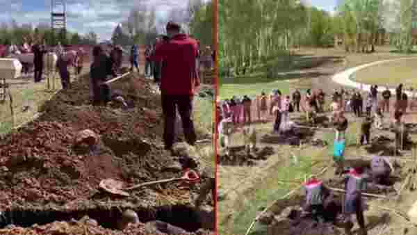 Koronayla mücadele eden Rusya'da tepki çeken olay! 'Hızlı mezar kazma' yarışması düzenlediler