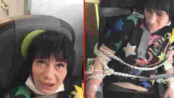 Uçakta yolcuları rahatsız edip soyunmaya çalışan kadını koltuğa bağladılar